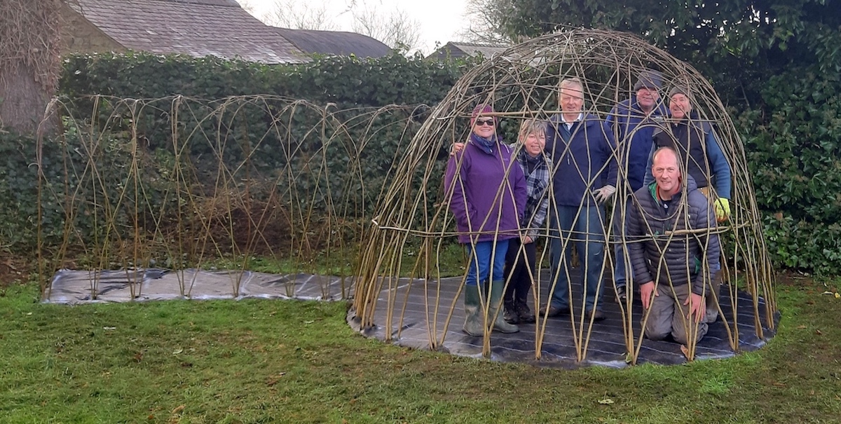 Clive's Renshaws Field Association pose in their willow dome